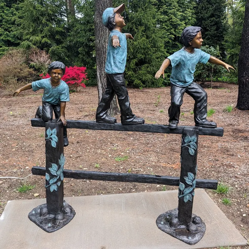 Bronze Balancing Act Trio On Fence Statue 1
